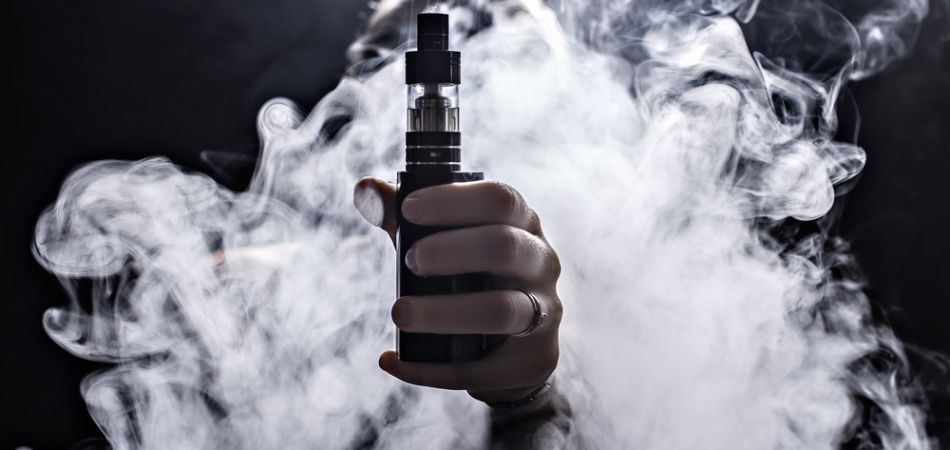 vaping-person-holding-vape-surrounded-by-smoke